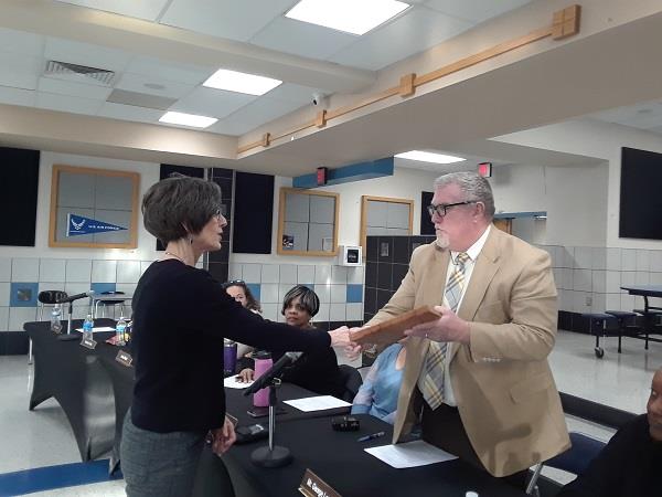 Mary Beth Lopez receives plaque from George Lammay